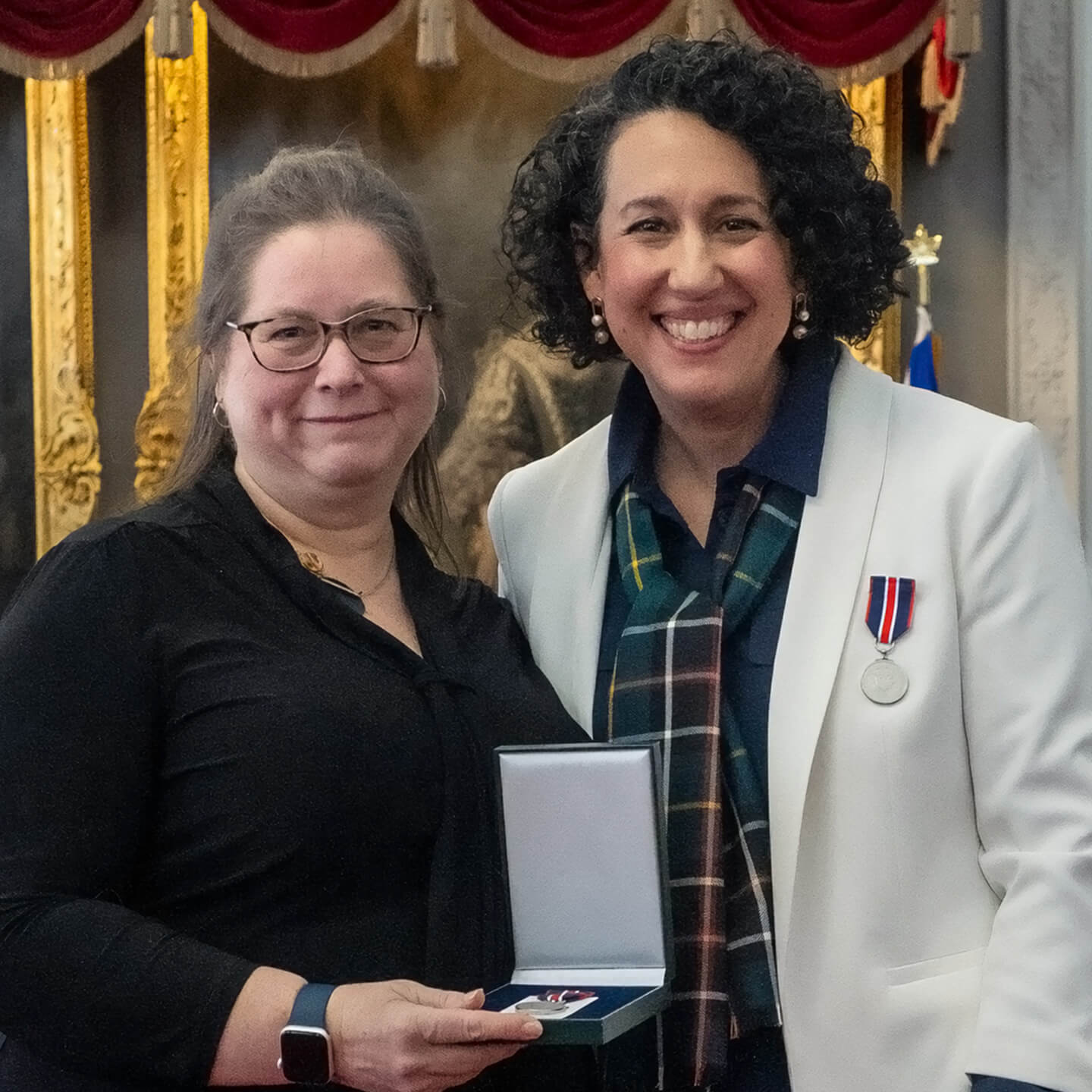 Posing for photo accepting the award.
